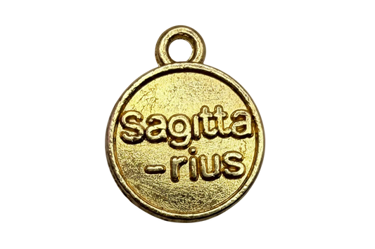 Round gold medallion with raised Sagittarius lettering and textured finish