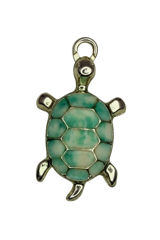 Gold turtle charm with seafoam and pale blue mosaic shell on black background