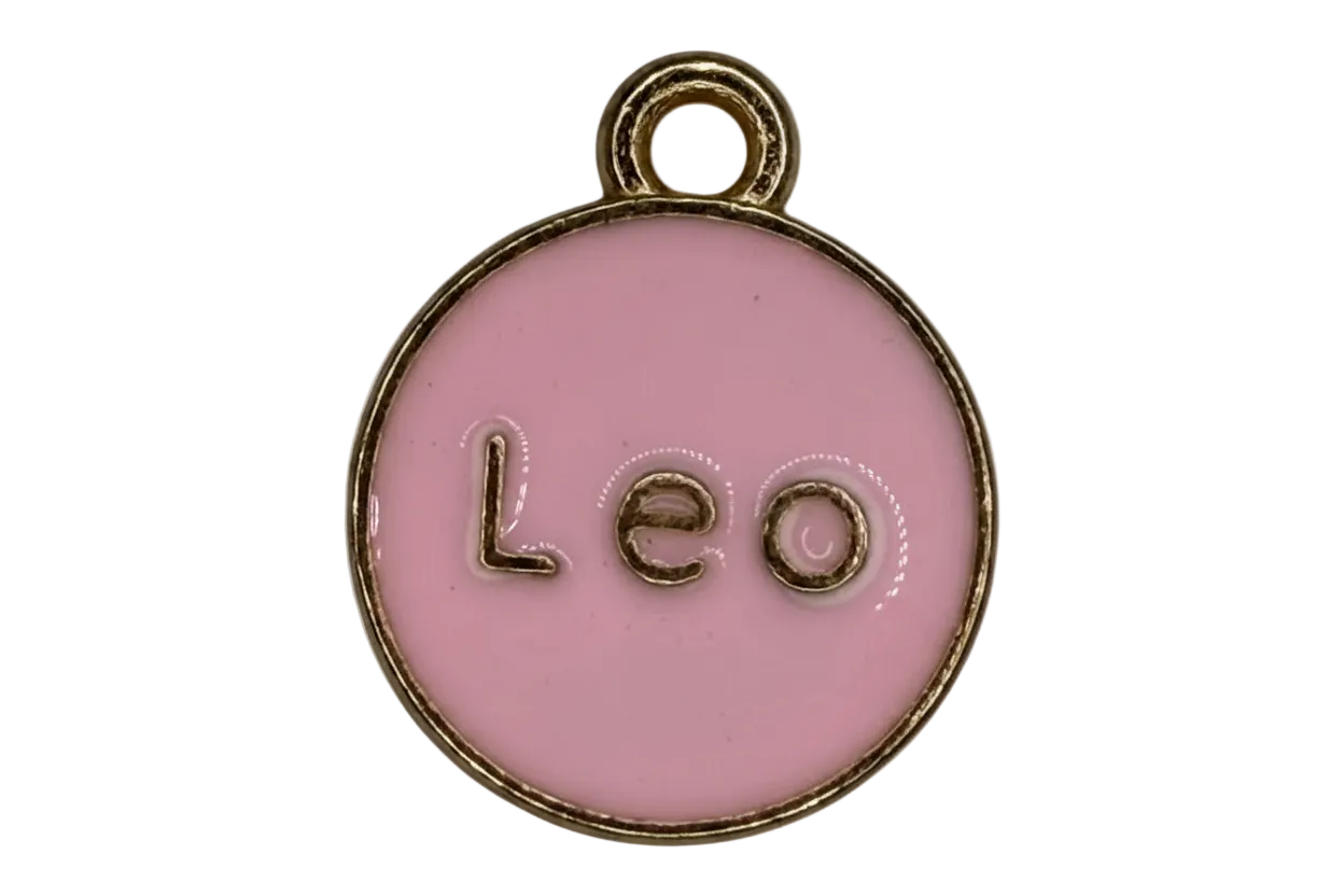 Round pink enamel Leo zodiac medallion with raised gold lettering and gold rim