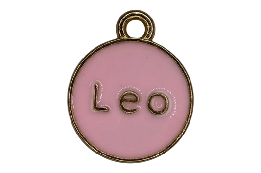 Round pink enamel Leo zodiac medallion with raised gold lettering and gold rim