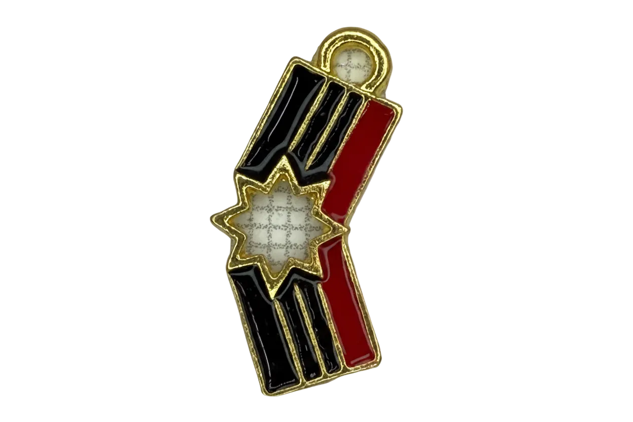 Gold striped ribbon charm with black and red enamel and an ivory starburst center