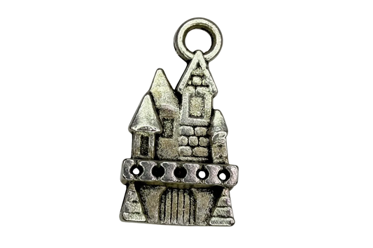Antiqued silver castle silhouette charm with tower and stonework details