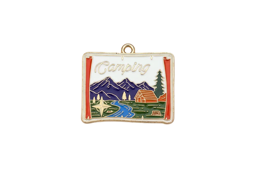 Gold-tone postcard pendant with enamel camping scene, mountains, river, cabin, and “Camping” script