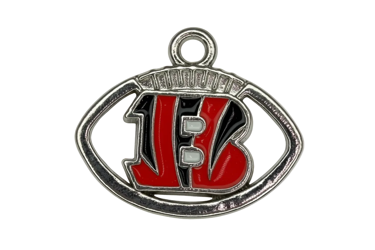 Silver football emblem with red varsity letters, black enamel fill, and white lace details
