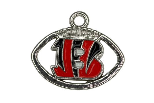 Silver football emblem with red varsity letters, black enamel fill, and white lace details