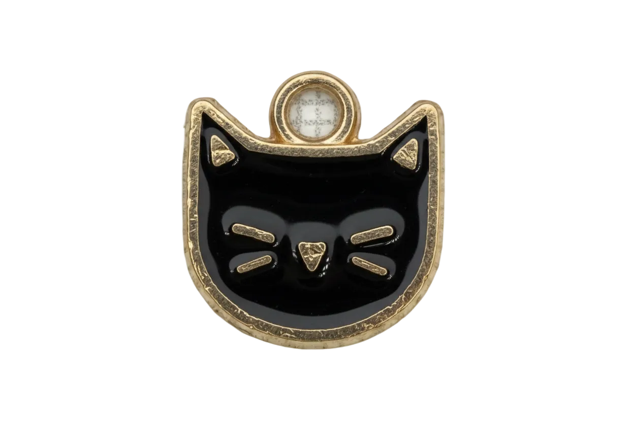 Glossy black cat face charm with gold outline and etched whisker details