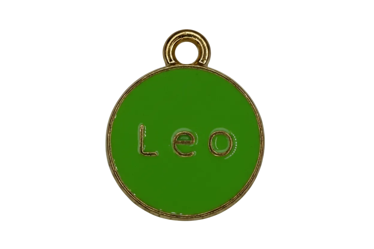 Glossy green round enamel disc with gold rim and raised “Leo” lettering
