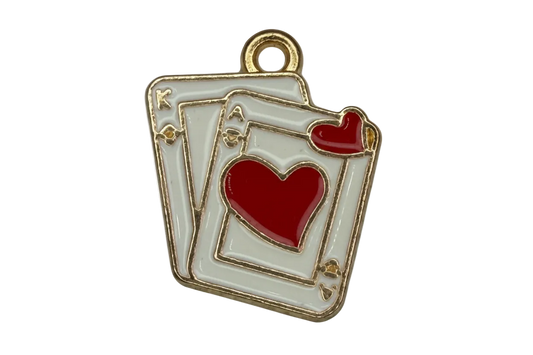 White enamel playing card stack with gold outline and red heart details on black background