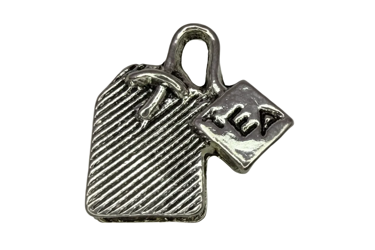 Silver-tone tea bag pendant with ridged texture and engraved TEA tag
