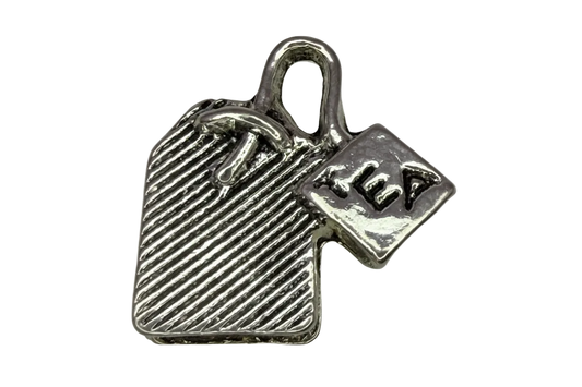 Silver-tone tea bag pendant with ridged texture and engraved TEA tag