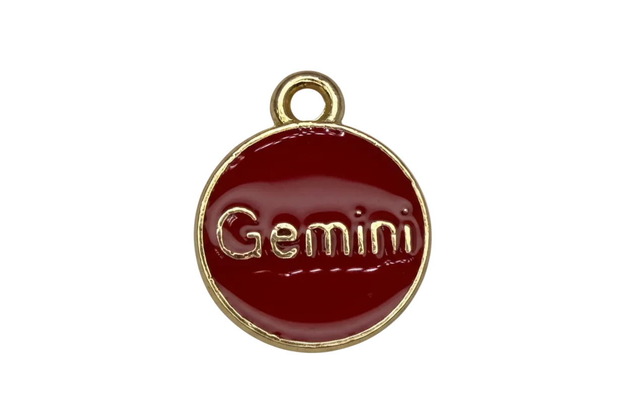 Glossy red enamel round disc with gold border and raised Gemini lettering