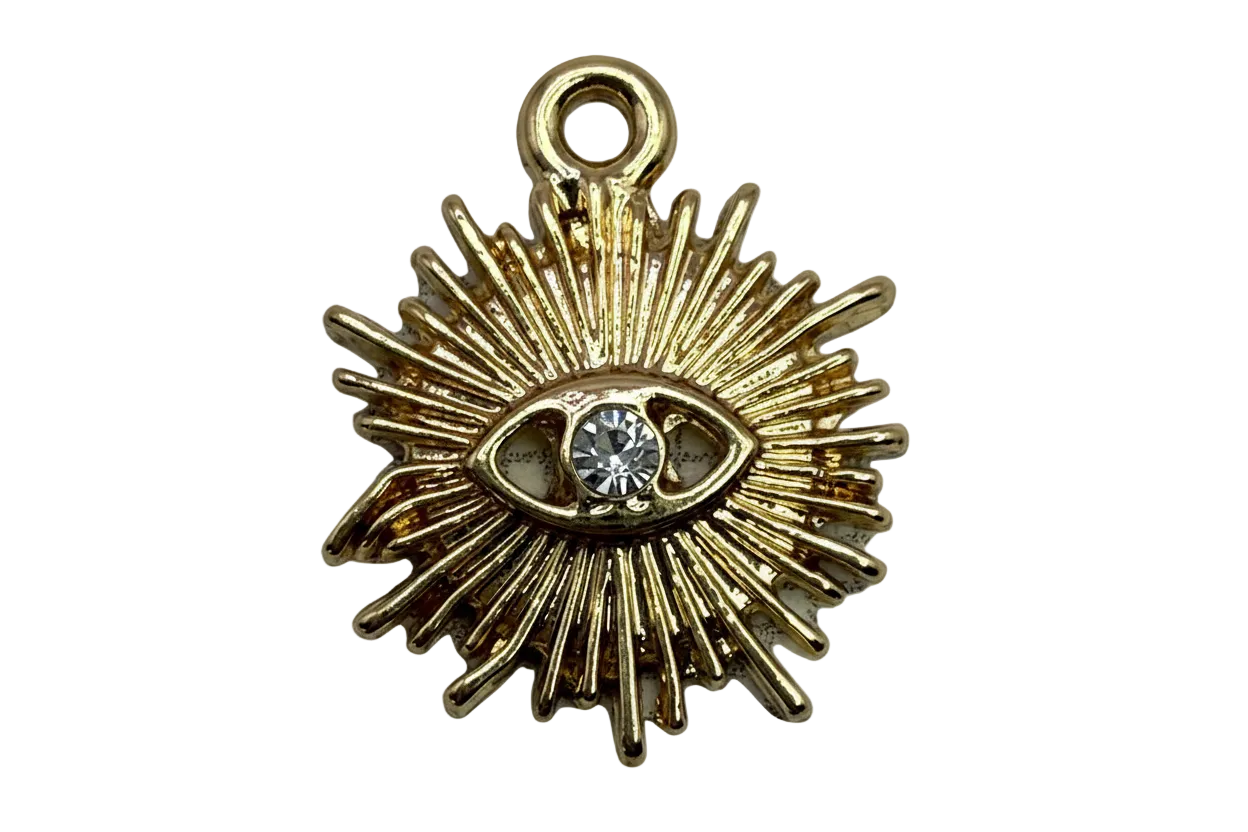Gold sunburst eye charm with a clear faceted crystal center