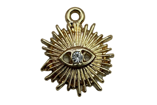 Gold sunburst eye charm with a clear faceted crystal center