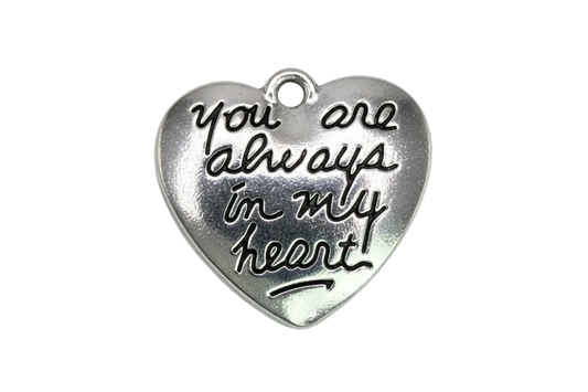 Polished silver heart with raised script reading “I love you to the moon and back”