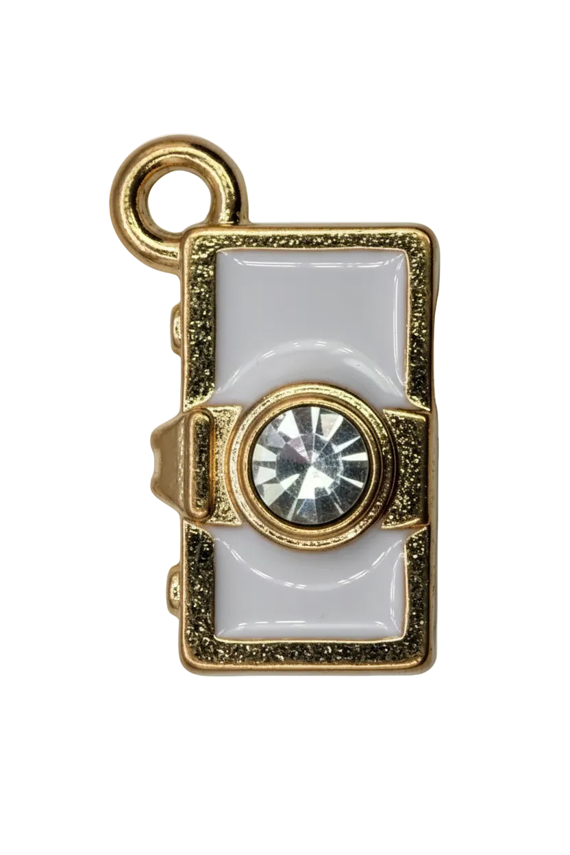 White enamel camcorder charm in gold with a clear faceted gem lens