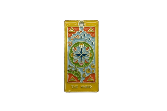 Gold rectangular tarot card charm with colorful enamel wheel motif and “THE WHEEL” text