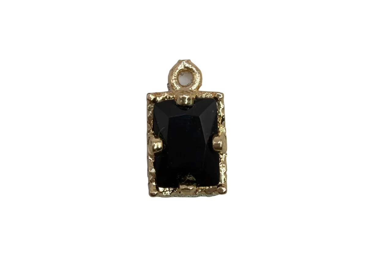 Faceted black rectangle gem in a gold frame
