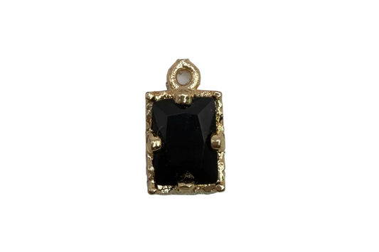 Faceted black rectangle gem in a gold frame