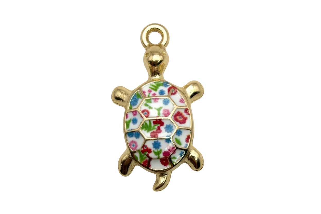 Gold turtle charm with glossy white shell and multicolor floral enamel pattern