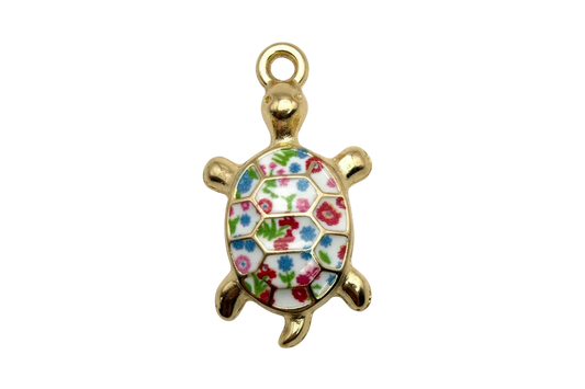 Gold turtle charm with glossy white shell and multicolor floral enamel pattern
