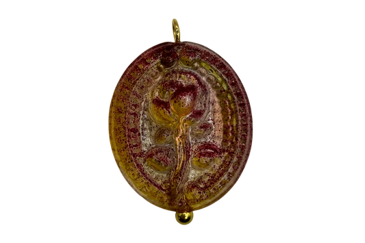 Oval cameo medallion in marbled burgundy and amber tones with gold-colored details