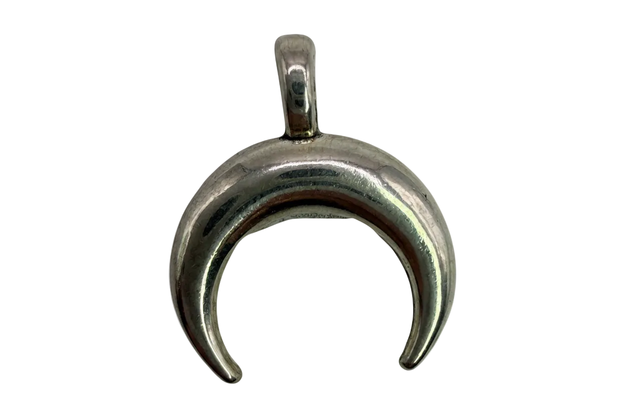 Polished silver crescent moon charm with a smooth, rounded sculptural finish