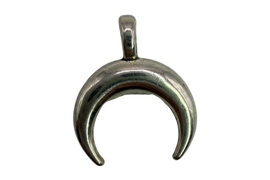 Polished silver crescent moon charm with a smooth, rounded sculptural finish