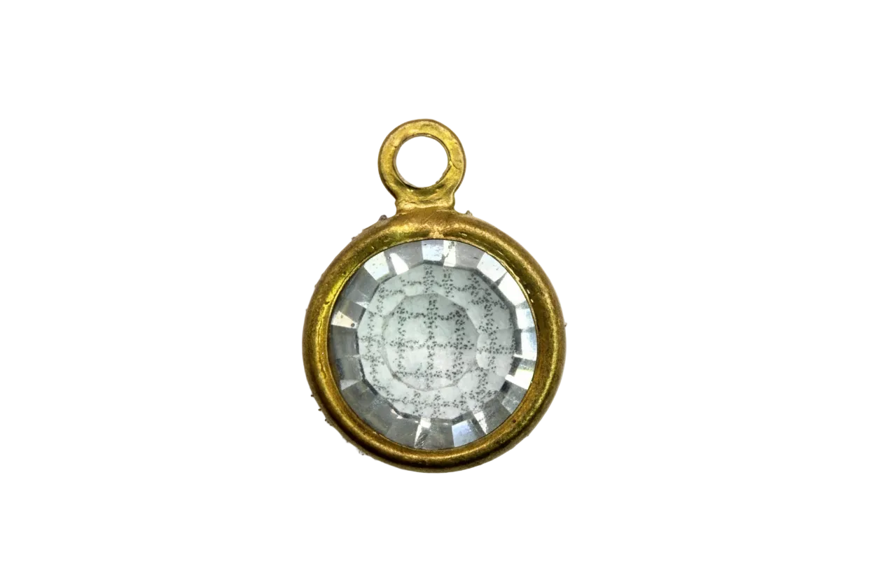 Faceted clear round crystal gem in a gold frame with subtle iridescent reflection