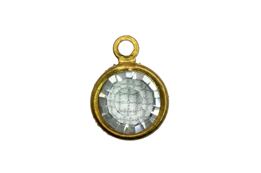 Faceted clear round crystal gem in a gold frame with subtle iridescent reflection