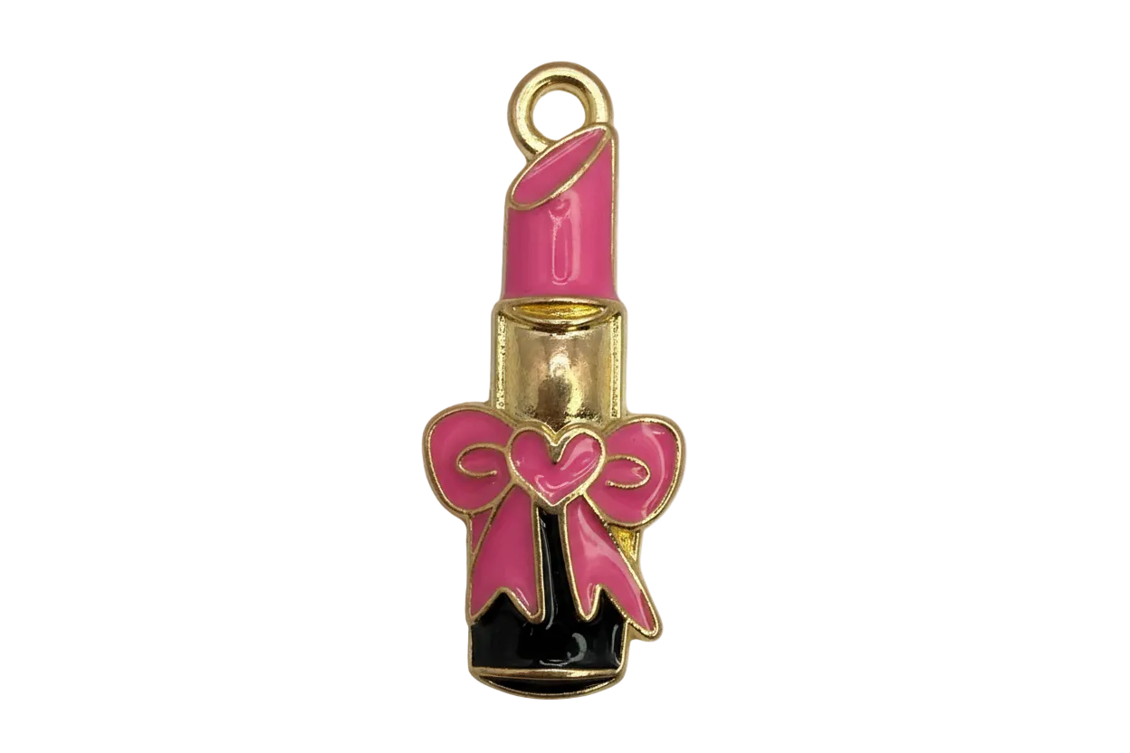 Gold lipstick tube charm with pink enamel bow and heart detail, black base
