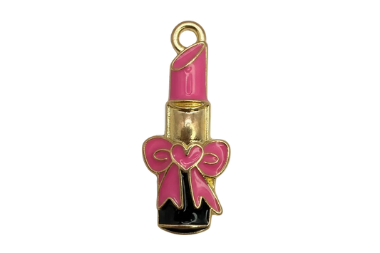 Gold lipstick tube charm with pink enamel bow and heart detail, black base