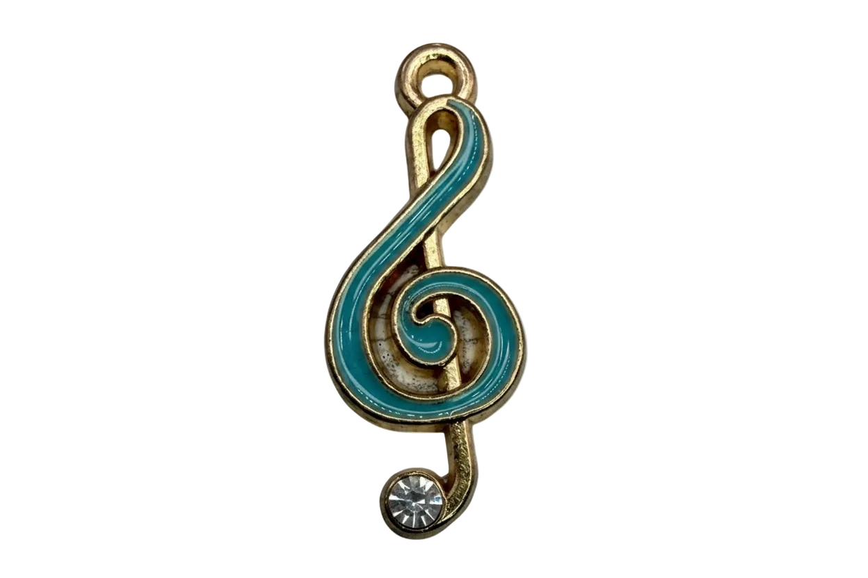Gold treble clef note with teal enamel and a clear crystal accent