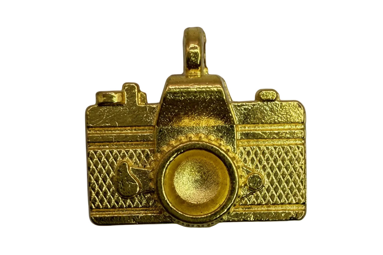 Gold camera charm with textured body and raised circular lens