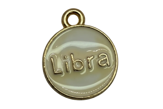 Ivory enamel round disc with raised Libra lettering and gold border