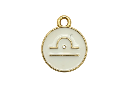 Round ivory enamel Libra zodiac disc with gold outline and scales symbol