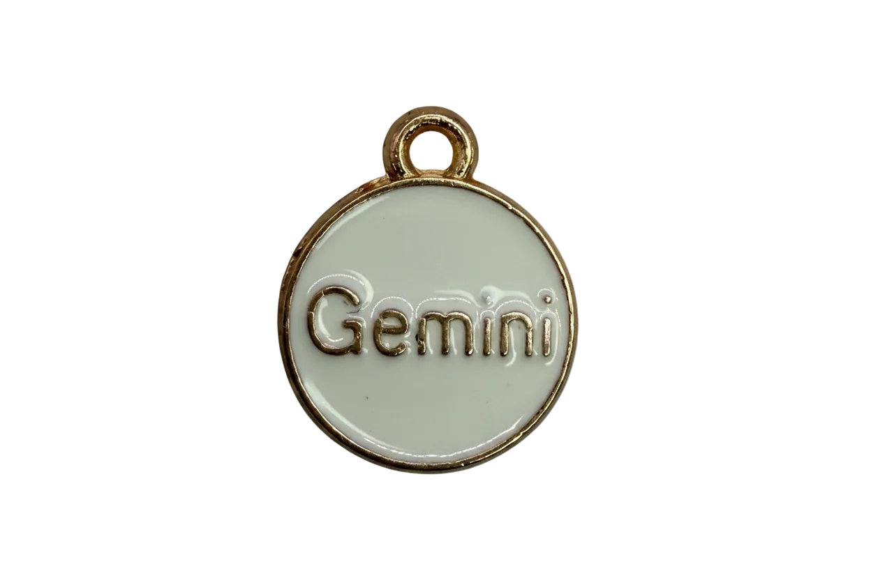 White round enamel medallion with raised gold "Gemini" lettering and gold rim