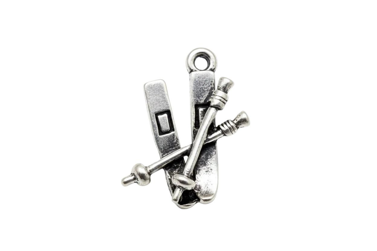 Antique silver ski set with crossed poles, vintage metal finish