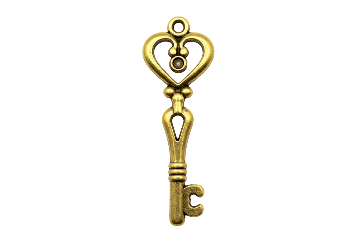 Ornate gold key charm with heart-shaped bow and polished finish
