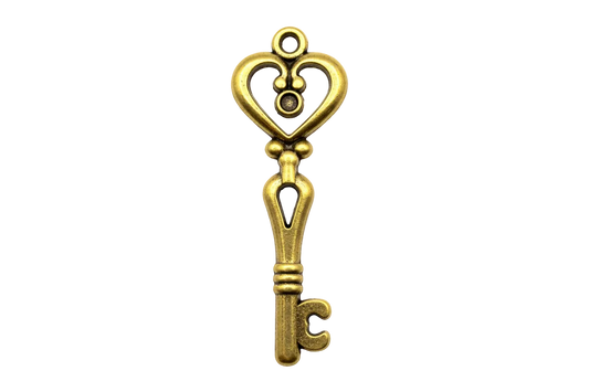 Ornate gold key charm with heart-shaped bow and polished finish