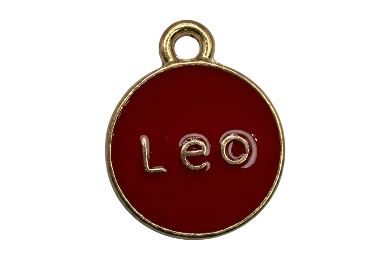 Red enamel round disc with raised Leo lettering and gold edge