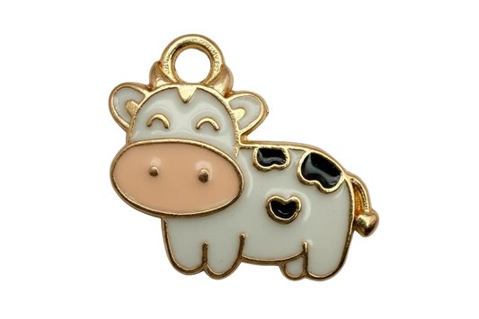 Gold-outlined enamel cow with white body, black spots, and blush pink snout