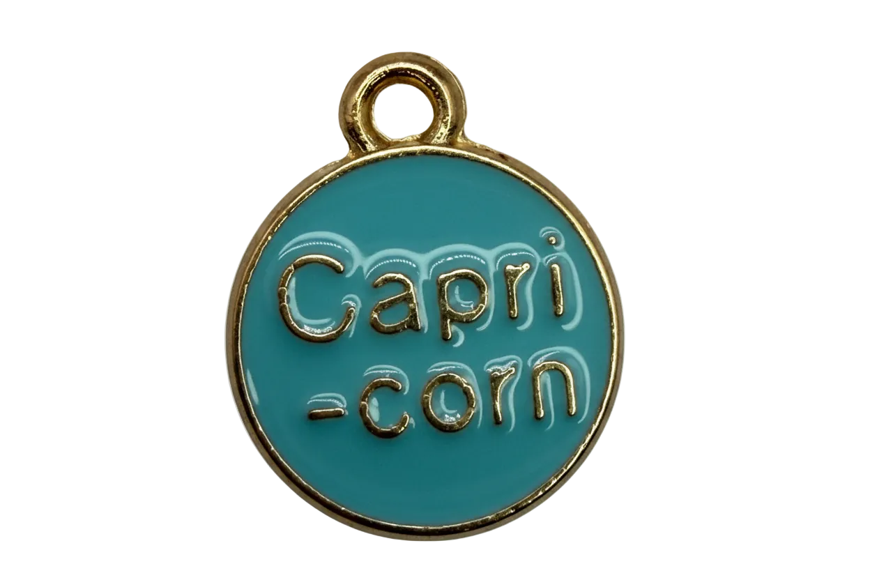 Round teal enamel coin with raised gold "Capri-corn" lettering and gold rim