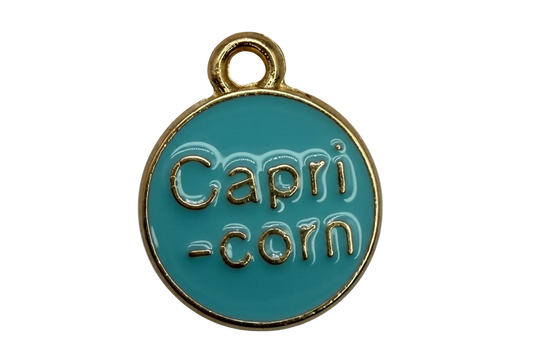 Round teal enamel coin with raised gold "Capri-corn" lettering and gold rim