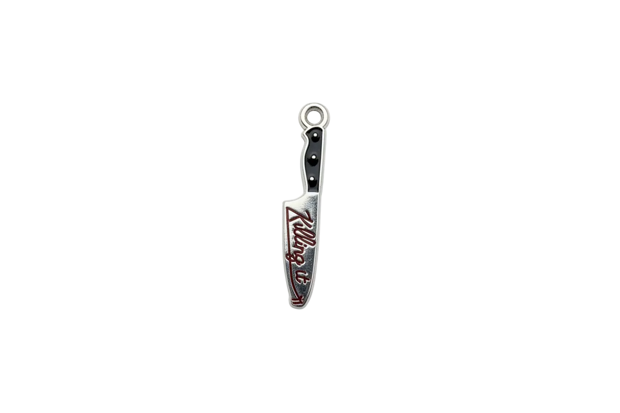 Silver knife charm with black handle and red script enamel