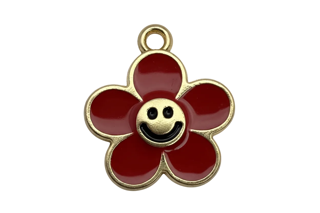 Gold-outlined red enamel flower with a smiley face center and a small clear gem accent