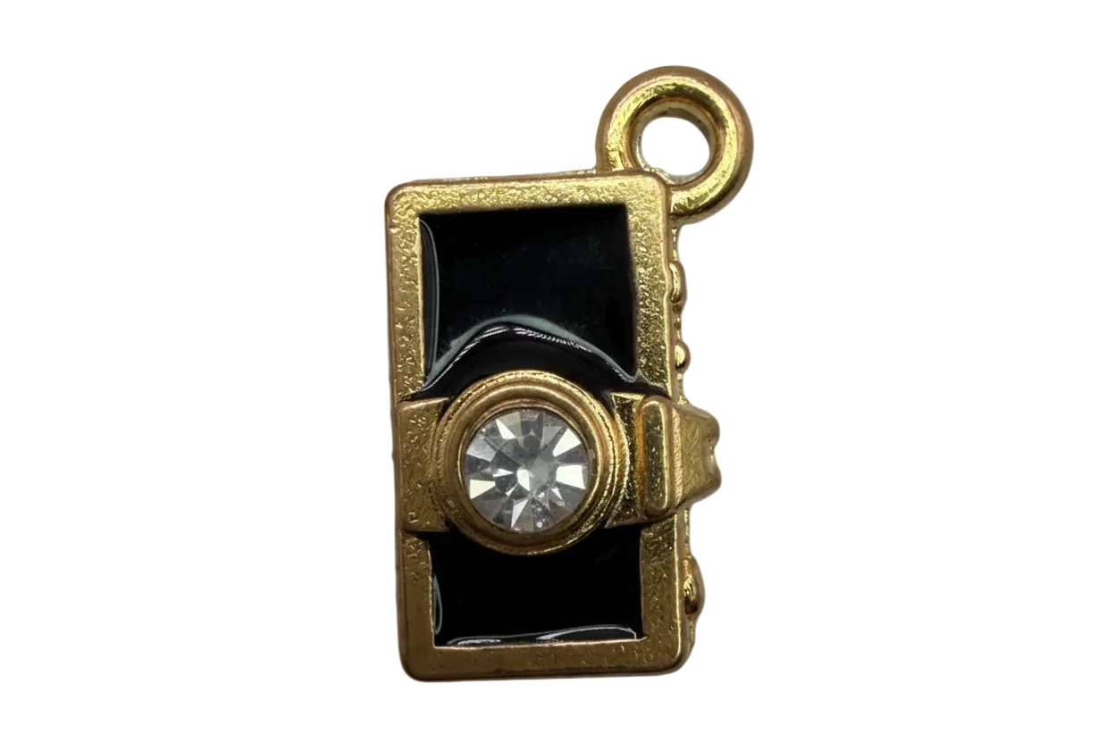 Gold camera charm with glossy black enamel and clear faceted crystal lens