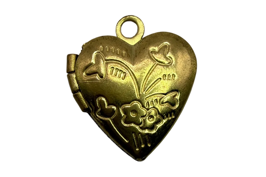 Gold heart locket with raised floral and star engravings and a satin finish