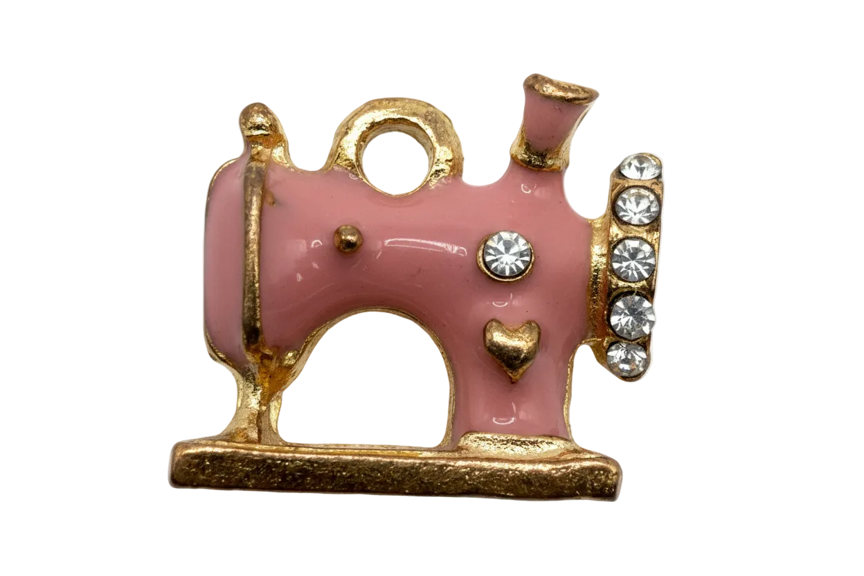 Pink enamel sewing machine with gold trim, heart detail, and clear crystals