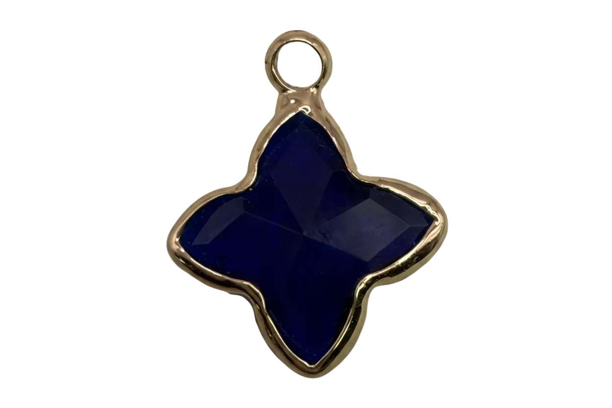 Faceted midnight blue quatrefoil gem framed in gold