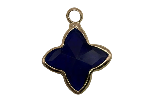 Faceted midnight blue quatrefoil gem framed in gold